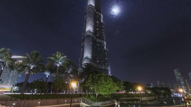 Dubai şehir merkezi ve aydınlatılmış Burj Halife zaman atlaması Dubai, BAE 'de. Arkasında ay olan dünyanın en yüksek binası, Birleşik Arap Emirlikleri..