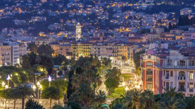 Evening aerial panorama of Nice day to night transition timelapse, France. Lighted Old Town little streets and Massena square after sunset. Traffic on the road clipart