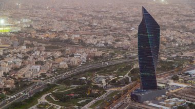 Kuwait City cityscape from top day to night transition timelapse with traffic on streets and highway. Illuminated towers. Located on the shore of the Persian Gulf. clipart