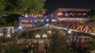 Illuminated Bridge of Sighs night timelapse hyperlapse. Tourists and locals crossing the Bridge of Sighs in the Barranco district of Lima Peru. clipart