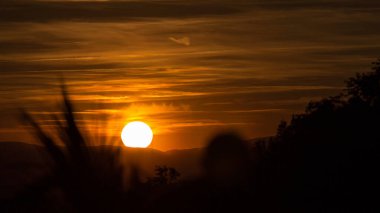 Madrid 'deki Debod Park Tapınağı yakınlarındaki günbatımı saatine hayranlar. Turuncu gökyüzü