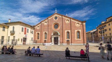 Santa Maria delle Grazie timelapse hyperlapse with blue cloudy sky. Milan, Italy. People sitting on a bench. This church and the adjacent Dominican convent were built during the 15th century. clipart