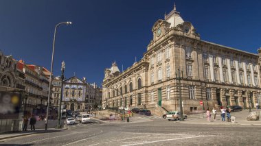 Traffic on Almeida Garret Square with the Sao Bento railway station and Congregados Church at the back timelapse hyperlapse, Porto, Portugal. Blue sky