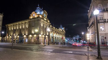 The crossroads with the illuminated Sao Bento Railway Station night timelapse hyperlapse. The building of station is a popular tourist attraction of Europe.