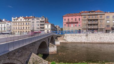 View of the Latin bridge with museum timelapse hyperlapse, one of the oldest bridges of Bosnia and Herzegovina, runs through the Milyacka River in Sarajevo at sunny day. Most Gavrila Principa clipart