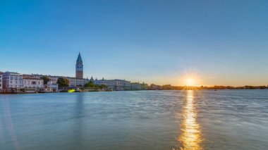Beautiful sunrise at Grand canal over San Marco square timelapse. Panoramic view from Church of Santa Maria della Salute, Venice, Italy, European Union. Famous historical heritage. Reflection on water