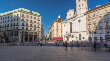 St. Michael's Church hyperlapse (Michaelerkirche), the church dedicated to Archangel Michael at Michaelerplatz (St. Michael's Square) across from St. Michael's Gate of Hofburg. People walking around clipart