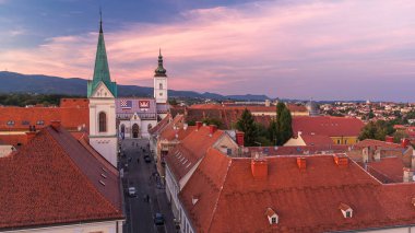 Church of St. Mark day to night transition timelapse and parliament building Zagreb, Croatia. Top view from Kula Lotrscak tower viewpoint after sunset