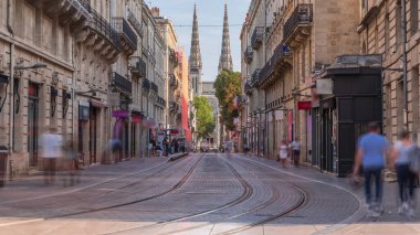 Tarihi şehirde hareket eden bir tramvayın yer aldığı Vital Carles caddesinden Bordeaux Katedrali 'nin (Cathedrale Saint Andre) Timelapse' si. İnsanlar tramvay durağında bekliyor. Bordeaux 'nun mirasının bir sembolü. Fransa