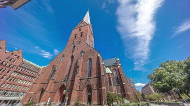 St. Peter Kilisesi ya da Hauptkirche St. Petri zaman atlaması Hamburg, Almanya 'da. Bu Protestan Luteryan kilisesinde yüksek kulesi, trafiği ve mavi gökyüzü arkaplanı olan gotik mimari yer almaktadır.