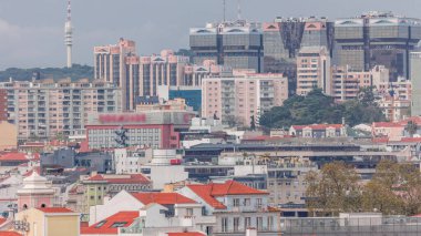 Aerial view of Lisbon skyline with Amoreiras shopping center towers. Historic buildings district with green trees and TV antenna tower timelapse from Miradouro da Graca viewpoint. Lisbon, Portugal clipart