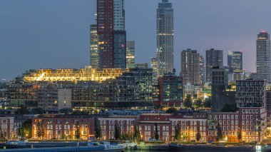 Panoramic aerial night to day transition timelapse of Katendrecht peninsula and Maashaven harbour in Rotterdam, The Netherlands. City skyline modern skyscrapers and traditional Dutch waterfront houses clipart