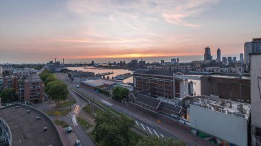 Rotterdam 'daki Katendrecht ve Maas Nehri gibi demirli gemilerle Maashaven' daki hava panoramik görüntüsü günden geceye geçiş zamanı. Eski fabrika yakınlarındaki trafik ofis ve etkinlik alanına dönüştü