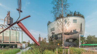 Hyperlapse of Depot Boijmans Van Beuningen in Rotterdam, Netherlands. Mirrored art storage reflects sunset over a reed pond. Located near Museum Boijmans, it is the first publicly accessible depot clipart