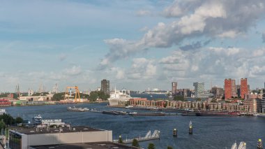 Aerial timelapse view over Maashaven with moored inland ships, Katendrecht and Maas River in the background. Dramatic cloudy sky over skyscrapers with warm morning light. Cargo port on a background clipart