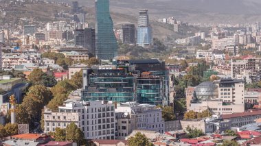 Glass towers of hotels and offices in Tbilisi aerial timelapse, skyscrapers of Georgia, located on Rustaveli Avenue. Historic buildings around. View from viewpoint clipart