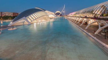 Valencia 'nın Sanat ve Bilim Şehri' nin, fütüristik mimari üzerine dolunay yansıması serin sulara yansıyan panoramik günden geceye geçiş zamanı. Büyüleyici bir İspanyol kültürel simgesi