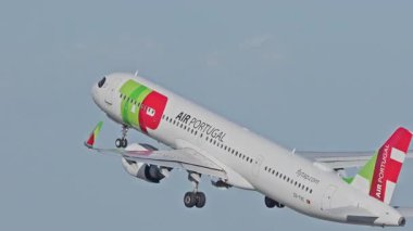 Lizbon, Portekiz - 25 Şubat 2025: Lizbon Havaalanı 'ndan kalkan uçak. TAP Air Portugal uçaklarının yakın çekim görüntüleri şehrin ufuk çizgisi ve havaalanı altyapısı ile birlikte pistten kalkıyor.