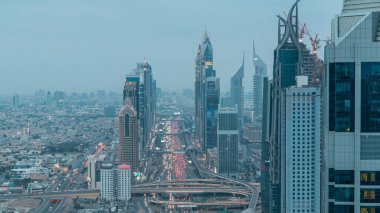 Dubai Şeyh Zayed Yolu kavşağındaki trafik günden geceye Dubai şehir merkezi yakınlarındaki geçiş zamanı bu yolların yoğunluğunu gösteriyor. Gün batımından sonra kuleden gökyüzü görüntüsü