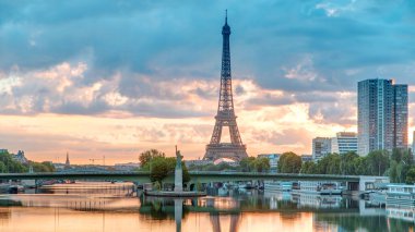 Eyfel Kulesi, Seine Nehri 'nde ve Fransa' nın Paris şehrinde teknelerle gün doğumu zamanı. Mirabeau Köprüsü 'nden görüntü. Modern binalar ve Özgürlük Anıtı. Dramatik gökyüzü