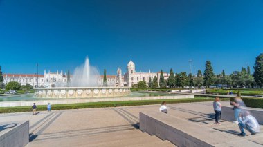 Jeronimos monastery and fountain seen from the Imperio garden timelapse hyperlapse in Lisbon, Portugal. People walking around and making pictures