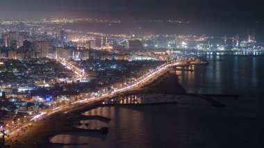 Sharjah 'ın panoramik manzarası gece yarısı Ajman' ın çatısından görülebiliyor. Birleşik Arap Emirlikleri 'nin üçüncü büyük ve en kalabalık şehri. Şerife, Körfez Körfezi 'nin kuzey kıyısında Arap Yarımadası' nda yer almaktadır.