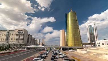 Kazakistan 'ın Nur-Sultan şehrinin merkezindeki sarı kule yakınlarında trafik ve araba park zamanı hızlandırılmış. Astana şehri çeşitli modern mimarisi ile ünlüdür..