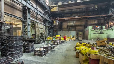 The liquid metal is poured into molds at the metallurgical plant timelapse hyperlapse. Worker controlling metal melting in furnaces. Factory workshop with steelmaking furnace