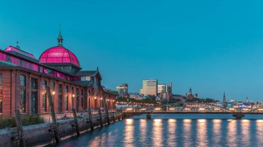 Hyperlapse of Altona Fish Market in Hamburg transition from day to night. Historic market with illuminated buildings reflecting on the Elbe River. Scenic view of trade, culture and vibrant waterfront clipart