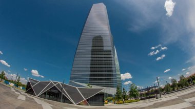 Madrid ve İspanya 'nın en yüksek gökdelenlerinin bulunduğu Dört Kuleler İş Alanında gökdelenler zaman atlaması yaşıyor. Bulutlu mavi gökyüzü. balık gözü