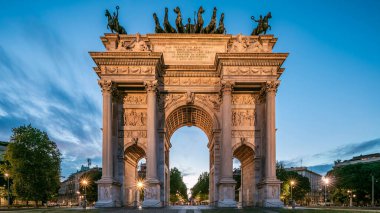 Piazza Sempione 'deki Arco della Pace (Simplon Meydanı' ndaki Barış Kemeri) günden geceye geçiş zamanı. Akşam aydınlatması. Bu neoklasik bir zafer kemeri.