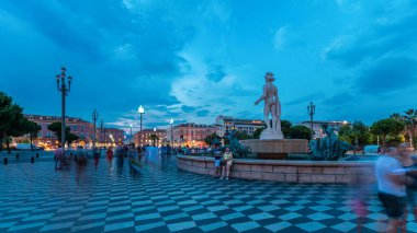 Place Massena Meydanı 'ndaki Fountain du Soleil. Günbegün geçiş zamanı, Fransız Riviera, Cote d' Azur, Fransa. Sokak lambaları ve aydınlık binalar