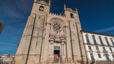 Porto Cathedral or Se Catedral do Porto timelapse hyperlapse front view with blue sky at sunny day. Romanesque and Gothic architecture.