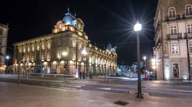 The crossroads with the illuminated Sao Bento Railway Station night timelapse hyperlapse. The building of station is a popular tourist attraction of Europe.