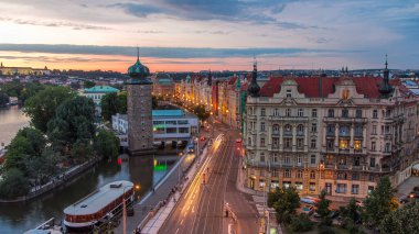 Sitkovska water-tower timelapse and traffic on road in old city center of Prague day to night transition. World Heritage Site of UNESCO. Aerial view from top of dancing house clipart