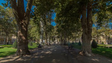 People walking around pavillion in Zrinjevac park timelapse hyperlapse in Zagreb, Croatia. Zrinjevac is spread over 12540 sq meters in city center. People relaxing on a bench