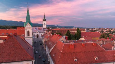 Church of St. Mark day to night transition timelapse and parliament building Zagreb, Croatia. Top view from Kula Lotrscak tower viewpoint after sunset