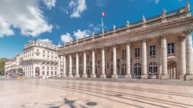 Büyük Bordeaux Tiyatrosu Fransa 'da zaman atlaması, Opera Ulusal ve Bale Ulusal' a ev sahipliği yapıyor. Sütunları olan neoklasik bir mimari mücevher. Mavi bulutlu gökyüzünün altında yürüyen insanlar