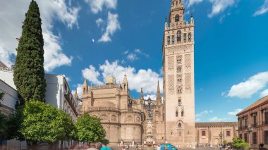 Seville Katedrali ve Giralda Kulesi Sevilla, İspanya 'da zaman atlaması. Dünyanın en büyük gotik katedrali olan UNESCO miras alanı Virgen de los Reyes Meydanı 'nda mavi gökyüzünün altında yer almaktadır.