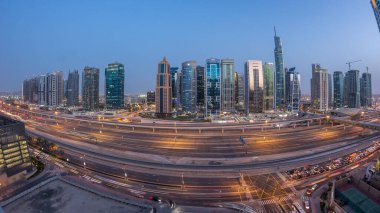 Jumeirah göl kulelerinin hava manzarası gökdelenler günden geceye geçiş zamanı Sheikh zayed yolu ve metro hattı trafiği.