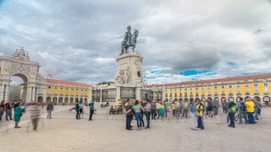 Bronze statue of King Jose I and triumphal arch at Rua Augusta at Commerce square timelapse hyperlapse in Lisbon, Portugal. Cloudy sky. Walking area