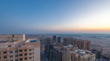 Ajman 'ın çatıdan şehre geçiş zamanının gece gündüz geçişi. Yeni bölge inşaatına bakın. Ajman, Birleşik Arap Emirlikleri 'nde Ajman Emirliğinin başkentidir.