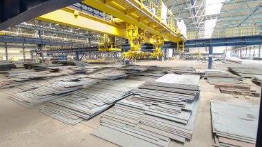 Factory workshop with lifting crane device timelapse hyperlapse, lift loads using lifting magnet, mechanical workshop, metal sheets structures on the floor of plant.