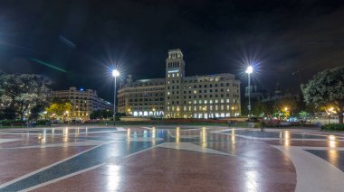 Orta Barselona 'daki Aydınlanmış Placa de Catalunya' nın Zaman Hızı. Şehir Merkezi Olarak Büyük Bir Meydan, Merkez Çeşme ve Gece Tepesi Arkaplanı Olarak Çiçek Yatağı
