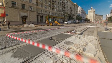 Concrete works and leveling for road construction with many workers in uniform and mixer machine timelapse. Reconstruction of tram tracks