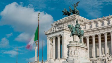 Rome, Italy. Famous Vittoriano with gigantic equestrian statue of King Vittorio Emanuele II timelapse. Blue cloudy sky and traffic on the road