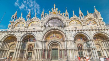 Basilica of St Mark timelapse hyperlapse. Front view of cathedral church of Roman Catholic Archdiocese of Venice. It lies at Piazza San Marco. Tourists walking in front of it. Venice, Italy