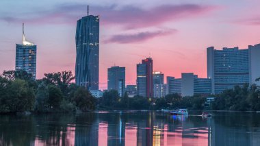 Viyana uluslararası merkez gökdelenleri Kaiserwasser Gölü yansıması ile gündüz gece geçiş zamanı, Avusturya 'nın başkenti Donaucity. Bulutlu renkli gökyüzü