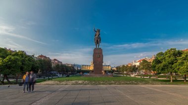 Monument of the Croatian King Tomislav timelapse hyperlapse and art pavilion in colorful park, in Zagreb, capital of Croatia. Blue cloudy sky before sunset. Panoramic view