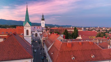 Church of St. Mark day to night transition timelapse and parliament building Zagreb, Croatia. Top view from Kula Lotrscak tower viewpoint after sunset